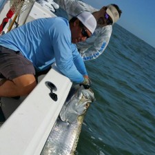 Charles Hull fighting severe Sea Sickness to get his victory shot after a mammoth battle with a giant Tarpon