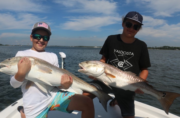 Young anglers with the victory pose