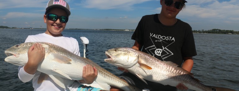 Young anglers with the victory pose