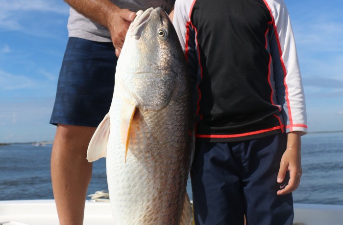 This little guy caught a Red as big as he is!