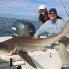 Father and daughter taming a toothy critter