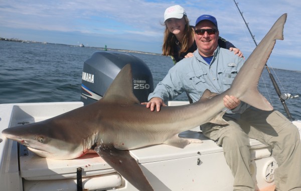 Father and daughter taming a toothy critter