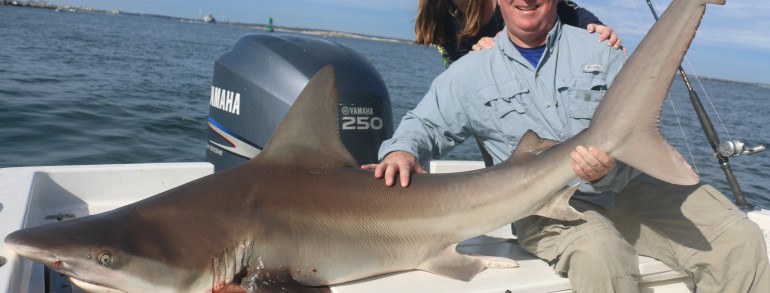 Father and daughter taming a toothy critter