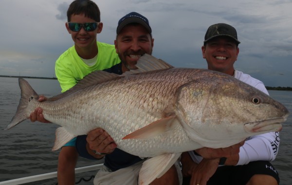 Rob Chapman of 360 Outdoors and crew with a Massive Bull Red