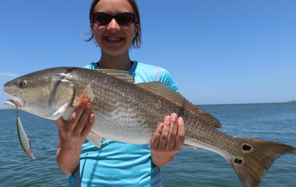 A young lady anger with an over slot Red on the Rapala XRap