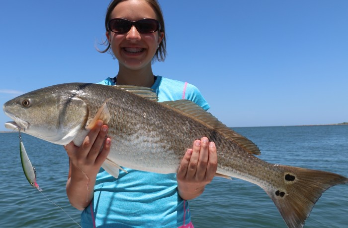 A young lady anger with an over slot Red on the Rapala XRap