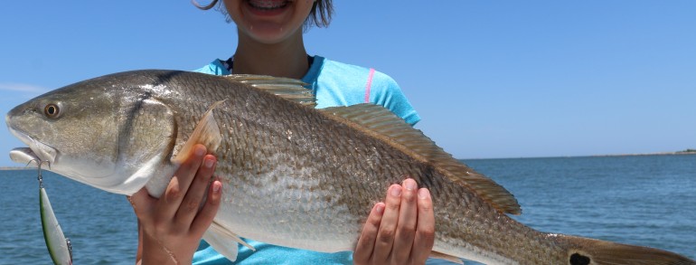 A young lady anger with an over slot Red on the Rapala XRap